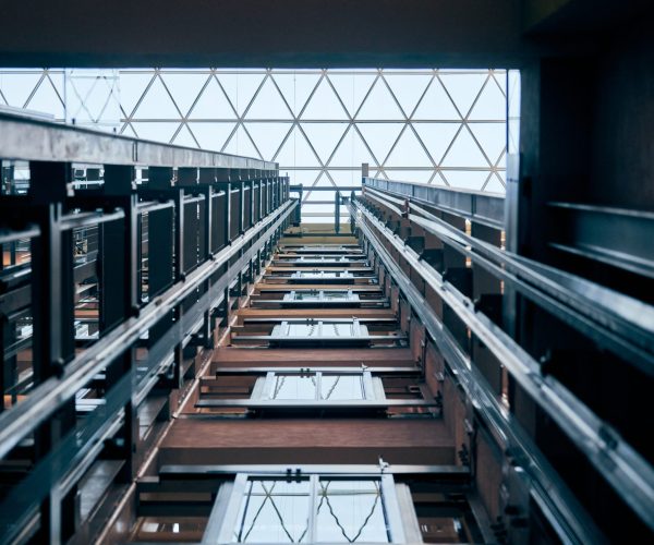 Open elevator lift shaft. Modern architecture with transparent ceiling. Shopping mall or business center. Maintenance repair and service