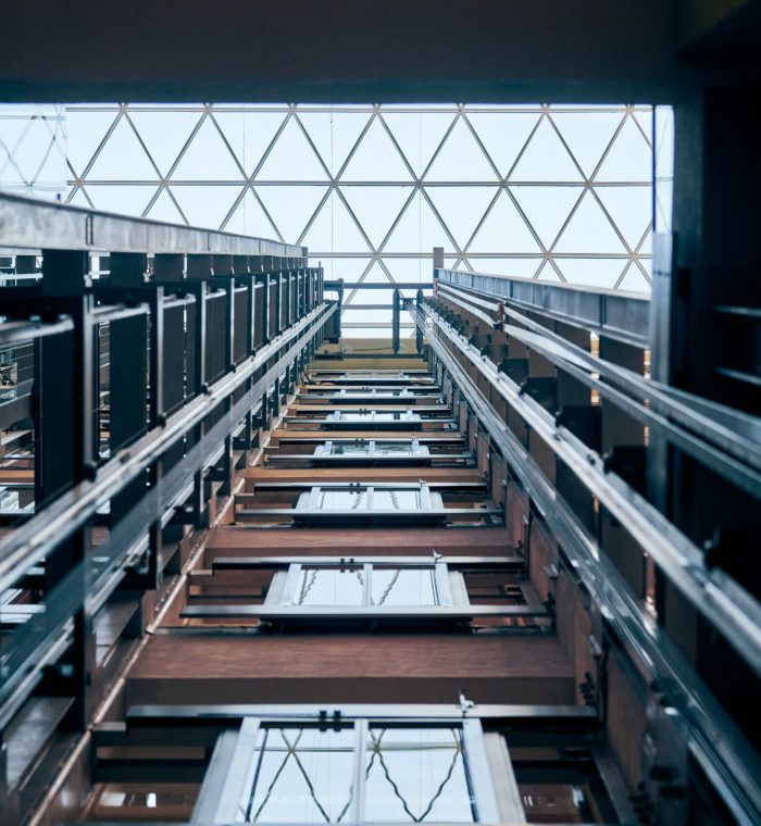 Open elevator lift shaft. Modern architecture with transparent ceiling. Shopping mall or business center. Maintenance repair and service