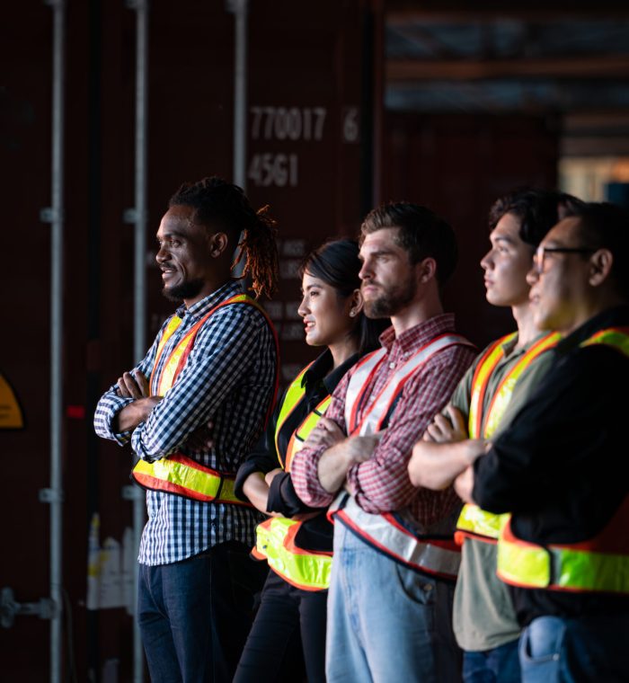 Portrait of group employees in the warehouse with arms crossed